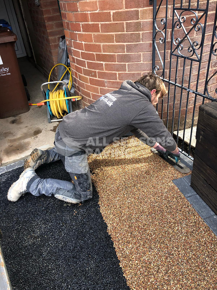 ASP worker installing rose resin driveway