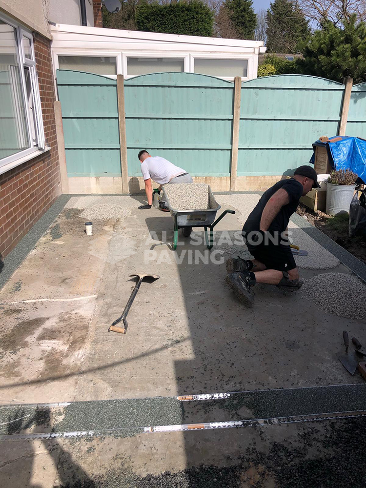 asp workers on resin grey driveway